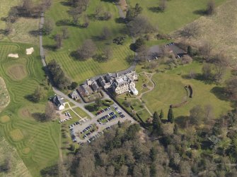 Oblique aerial view centred on the hotel with the stable block adjacent, taken from the SW.