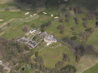 Oblique aerial view centred on the hotel with the stable block adjacent, taken from the SSE.