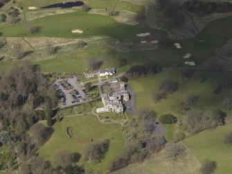 Oblique aerial view centred on the hotel with the stable block adjacent, taken from the ESE.