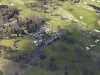 Oblique aerial view centred on the hotel with the stable block adjacent, taken from the NE.