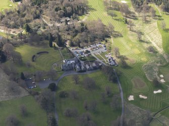 Oblique aerial view centred on the hotel with the stable block adjacent, taken from the NNE.