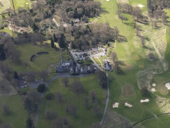 Oblique aerial view centred on the hotel with the stable block adjacent, taken from the NNE.