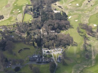 Oblique aerial view centred on the hotel with the stable block adjacent, taken from the N.