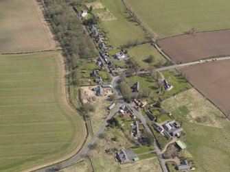 Oblique aerial view centred on the village taken from the W.