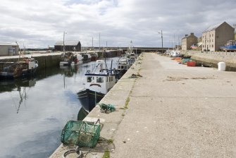 View from E showing North and S piers with harbour.