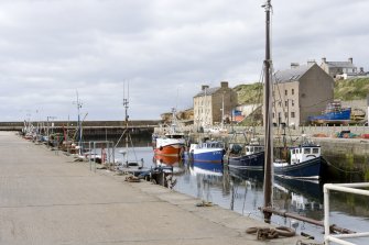 View from SE of harbour and part of North Pier and two warehouses.