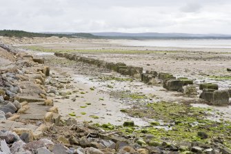 View from N showing re-used anti-tank blocks/cubes immediately S of the caravan park at Burghead.