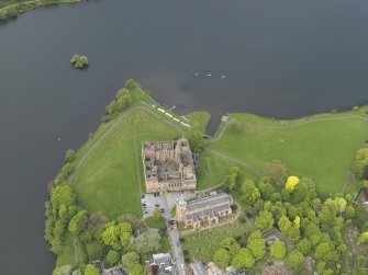 Oblique aerial view centred on the Palace with the parish church adjacent, taken from the S.