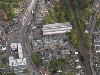 Oblique aerial view centred on the High Street, taken from the W.