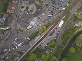 Oblique aerial view centred on the railway station, taken from the SW.