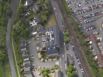 Oblique aerial view centred on the former distillery building, taken from the E.