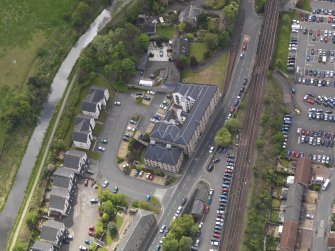 Oblique aerial view centred on the former distillery building, taken from the ENE.