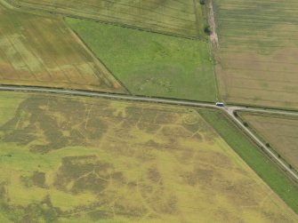 Oblique aerial view of the cropmarks of the barrow, taken from the NNE.