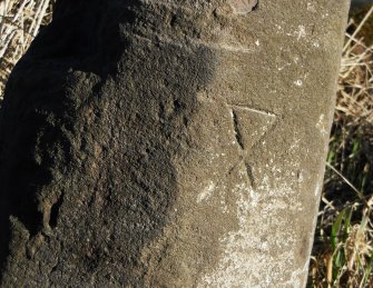 Detail of mason's mark on S side of milestone.