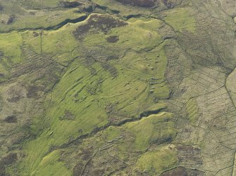 Oblique aerial view of the remains of the buildings, field boundaries and rig at Askaig, taken from the SSE.