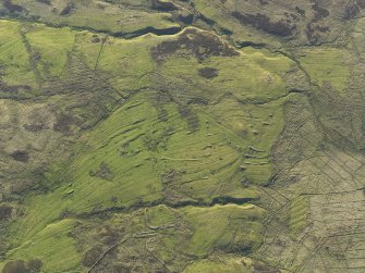 Oblique aerial view of the remains of the buildings, field boundaries and rig at Askaig, taken from the SE.