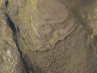 Oblique aerial view of the fort wall and enclosures on Ben Griam Beg, taken from the SSW.