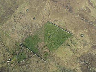 Oblique aerial view of the remains of the buildings, rig and field at Breac-Achadh, taken from the WSW.