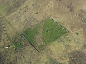 Oblique aerial view of the remains of the buildings, rig and field at Breac-Achadh, taken from the SW.
