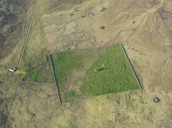 Oblique aerial view of the remains of the buildings, rig and field at Breac-Achadh, taken from the SSW.