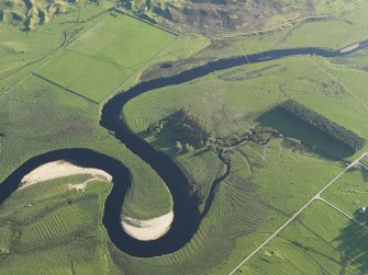 Oblique aerial view of the remains of the rig on the flood plain of the River Brora, taken from the NE.