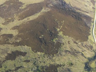 Oblique aerial view of the remains of the hut-circles and small cairns, taken from the SW.