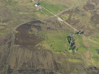 Oblique aerial view of the remains of the hut-circles and small cairns at Dremergid, taken from the WSW.