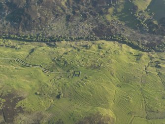 Oblique aerial view of the remains of the buildings and rig at Leataidh, taken from the NE.