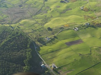 Oblique aerial view of the barrow at Knock Dhu with Balcharn beyond, taken from the S.