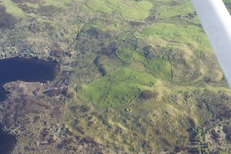 Oblique aerial view of the buildings, dykes, rig and hut-circles at Dola, taken from the NE.