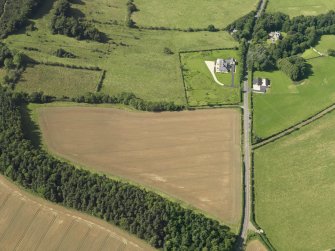 Oblique aerial view of the cropmarks of the field boundary, taken from the ESE.