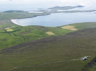 General oblique aerial view looking across Fitful Head with Sumburgh Airport in the distance, taken from the NW.