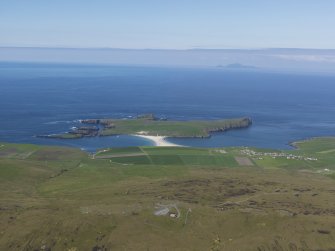 General oblique aerial view looking across the village of Bigton and St Ninian's Isle with Foula in the distance, taken from the E.