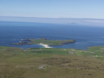 General oblique aerial view looking across the village of Bigton and St Ninian's Isle with Foula in the distance, taken from the E.