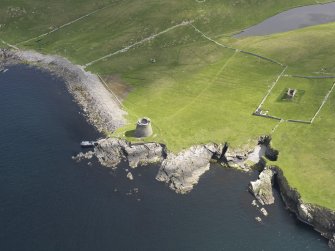 Oblique aerial view centred on the Broch of Mousa with The Haa and the burnt mound adjacent, taken from the SW.