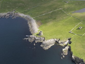 Oblique aerial view centred on the Broch of Mousa with The Haa and the burnt mound adjacent, taken from the SW.