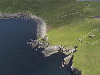 Oblique aerial view centred on the Broch of Mousa with The Haa adjacent, taken from the SW.