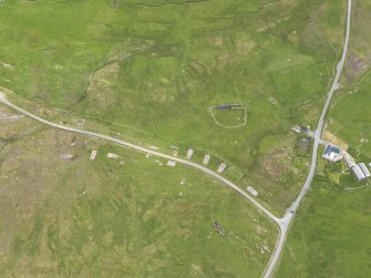 Oblique aerial view centred on the concrete floors of the military camp, looking ESE.