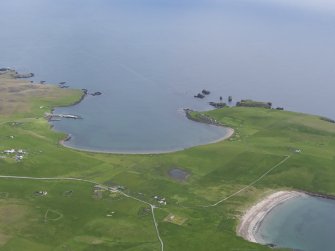 Oblique aerial view of Housa Voe and Kirk Sand, Papa Stour, looking NE.