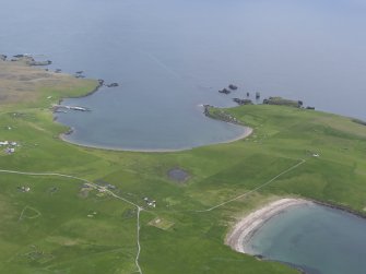 Oblique aerial view of Housa Voe and Kirk Sand, Papa Stour, looking NE.