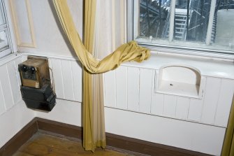 Interior. Detail of timber panelled window surround, with telephone fittings, within the hall recess