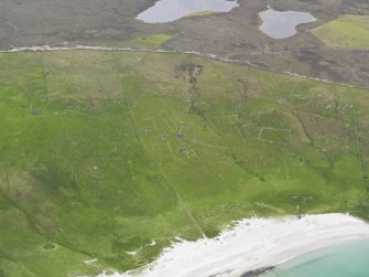 Oblique aerial view of the buildings and field systems at Sandwick, looking W.