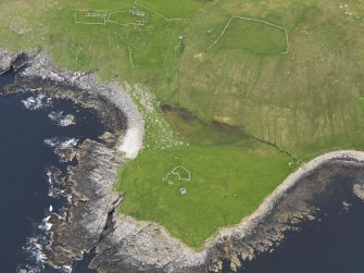 Oblique aerial view of Kirkaby Church, Unst, looking E.