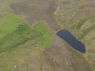 Oblique aerial view of the farmsteads and field systems and the Gossa Water, looking NE.
