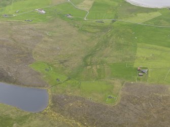 Oblique aerial view of the farmsteads and field systems, with the Gossa Water in the foreground and Westing beyond, looking WSW.