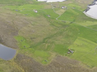 Oblique aerial view of the farmsteads and field systems, with the Gossa Water in the foreground and Westing beyond, looking WSW.