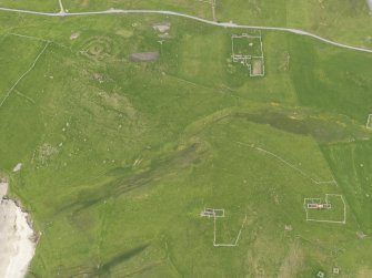 Oblique aerial view of the farmsteads, the Broch of Underhoull and the field systems, looking NE.