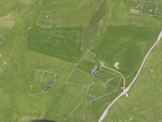 Oblique aerial view of the farmsteads, looking NW.