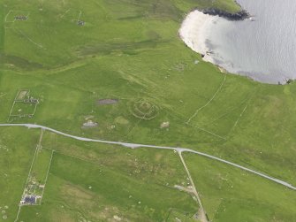 Oblique aerial view of the Broch of Underhoull and the field systems, looking SSW.