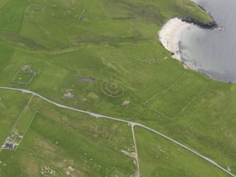 Oblique aerial view of the Broch of Underhoull and the field systems, looking SSW.